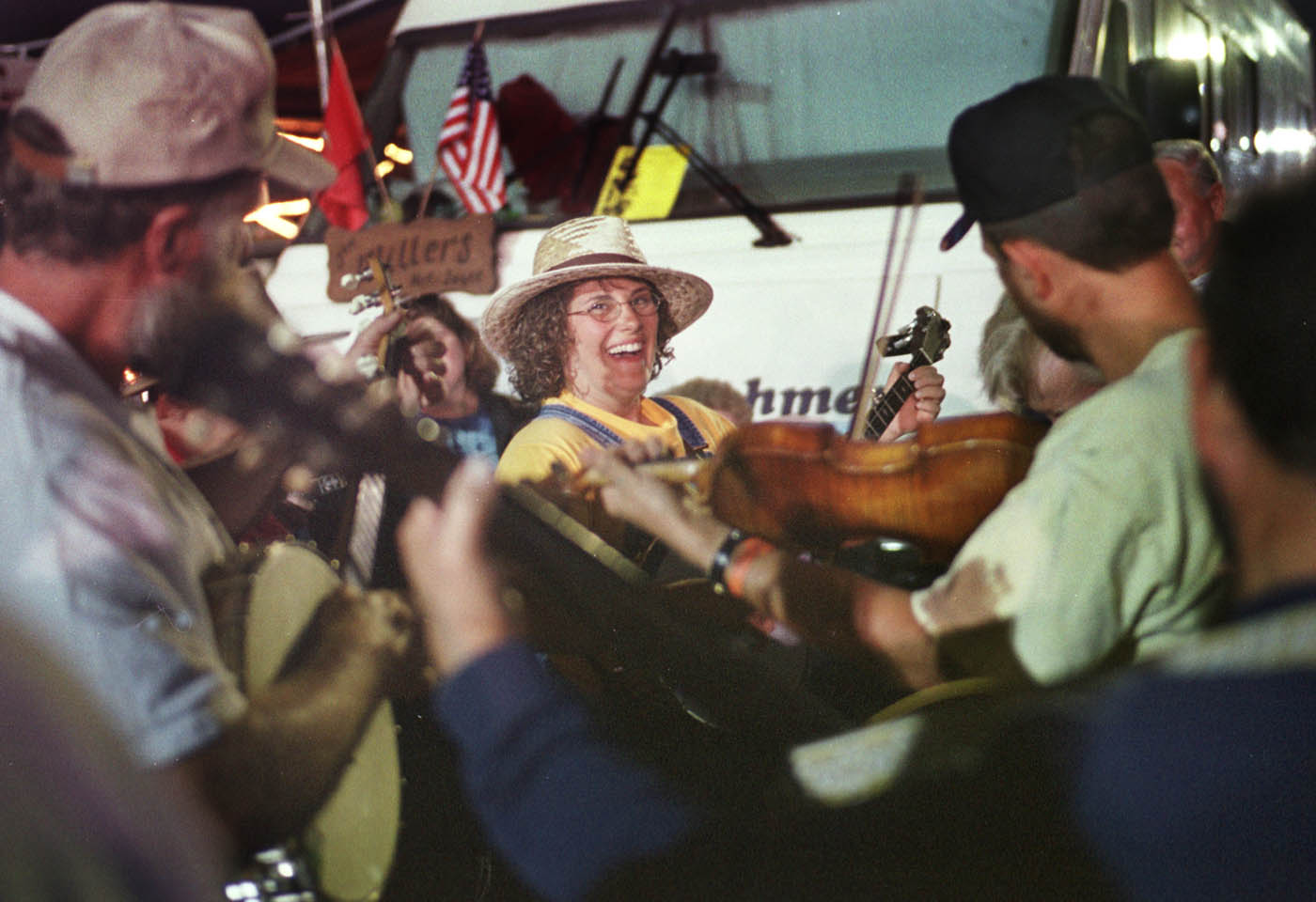 Trish Kilby, center, from Lancing, NC, was obviously having a great time picking banjo with The Blue Ridge Ramblers as they played in the campground area during the 67th Annual Old Fiddlers Convention in Galax, VA  Friday night,  August 9, 2002.    NOTE: FOR RT. 58 PROJECT.